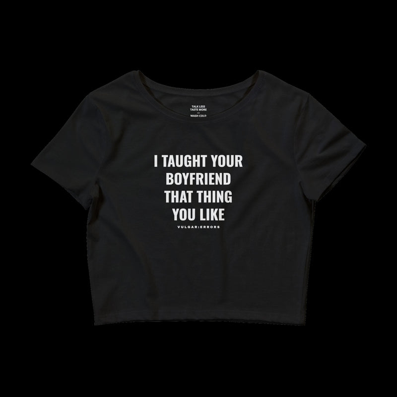 "I TAUGHT YOUR BOYFRIEND BABY TEE" Vulgar Errors cropped baby tee in black, back view showing the large white slogan back print