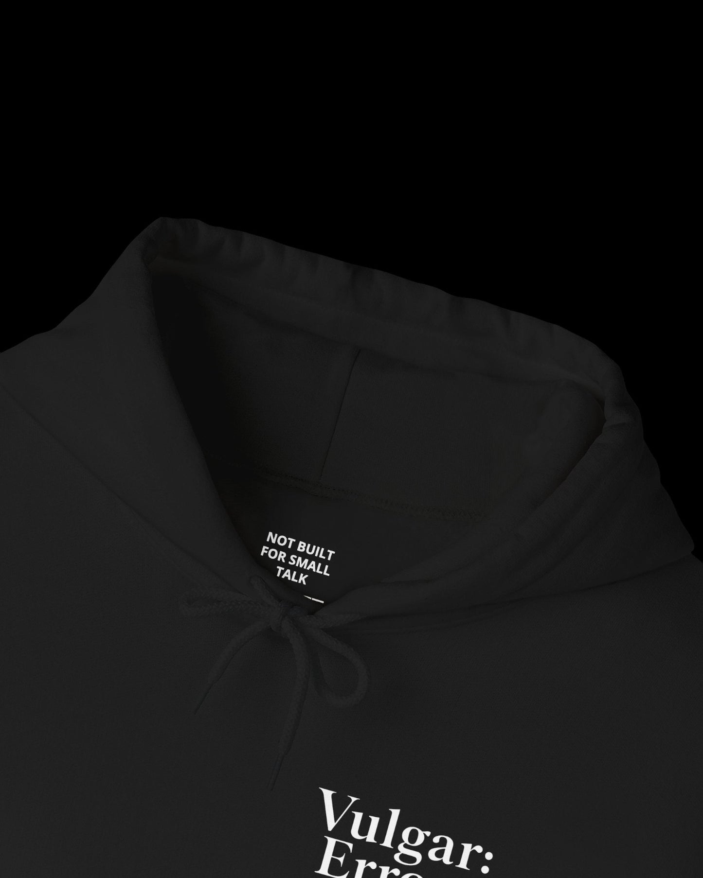 Inner neck label of black hoodie showing printed care guide, size, and cotton fabric details