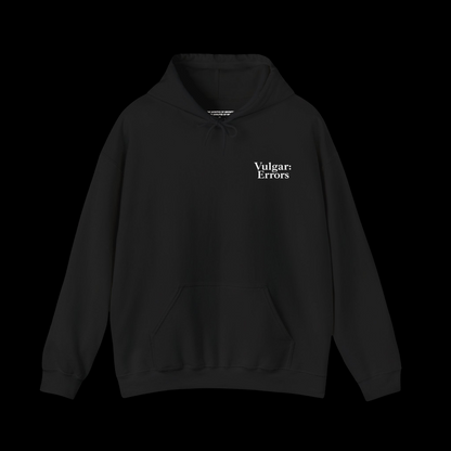 Vulgar Errors black pullover hoodie with a small white chest logo, featuring a relaxed unisex fit and front pocket.