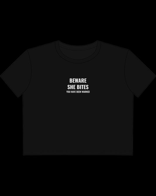 Vulgar Errors Beware She Bites Baby Tee with white chest slogan print on fitted black cotton