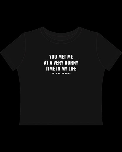 Back view of fitted black baby tee showing cropped shape, short sleeves, and clean cotton finish