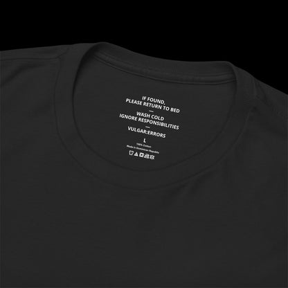 Inner neck label of the black "Bad At Life" Vulgar Errors t-shirt showing the printed care guide and size details
