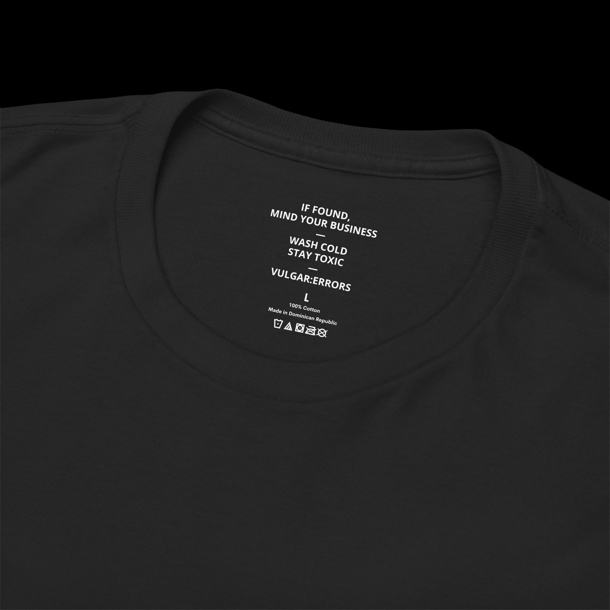 Inner neck label of the black "On A Fucking Spree" Vulgar Errors t-shirt showing the printed care guide and size details