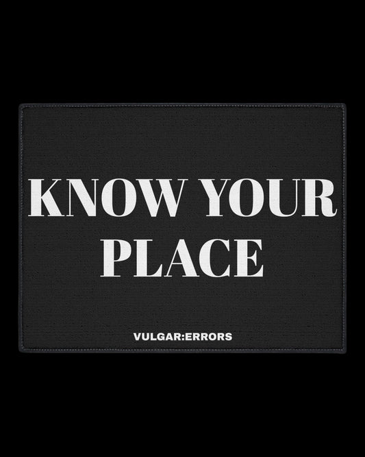 Vulgar Errors Know Your Place Doormat 18x27 inch with bold black slogan print on natural coir-style mat